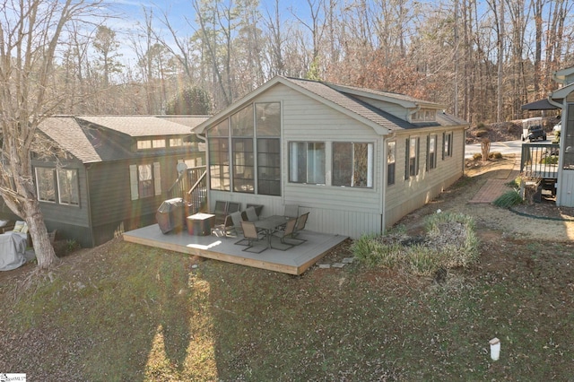 back of house featuring a patio area and a sunroom