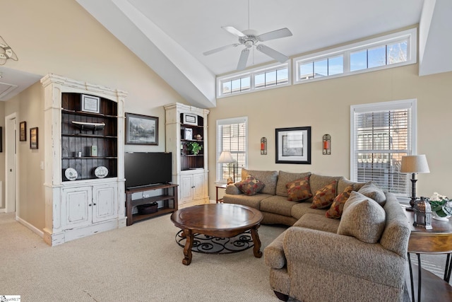 carpeted living room featuring ceiling fan and high vaulted ceiling