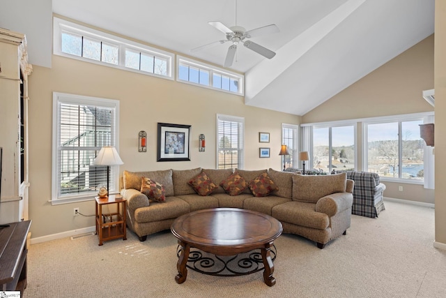 carpeted living room with a high ceiling and ceiling fan