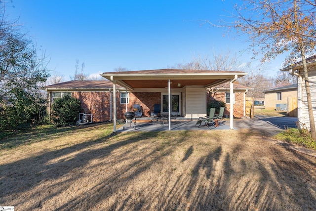 rear view of house with a yard and a patio area