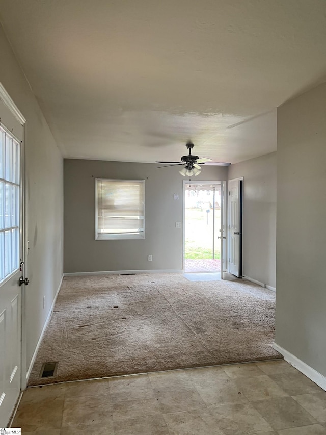 spare room featuring ceiling fan and light carpet