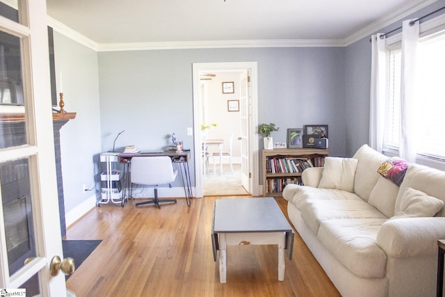 living room featuring a wealth of natural light, hardwood / wood-style floors, and ornamental molding