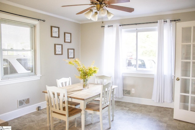 dining room with ceiling fan, plenty of natural light, and crown molding