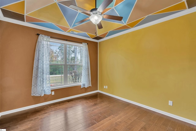 empty room featuring hardwood / wood-style flooring, ceiling fan, and crown molding