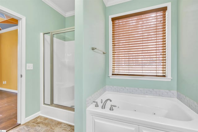 bathroom with ornamental molding and independent shower and bath