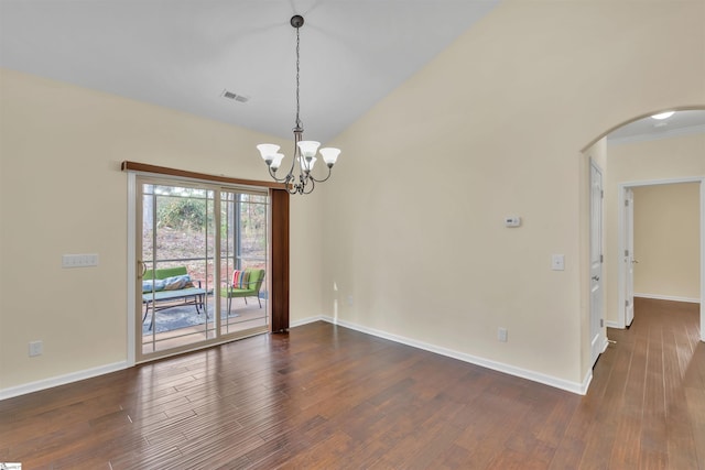 spare room featuring dark hardwood / wood-style flooring and a notable chandelier