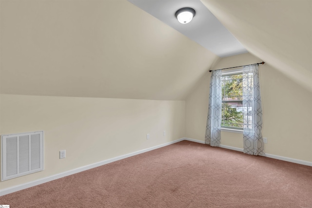 additional living space with carpet and vaulted ceiling