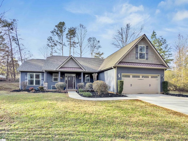 craftsman house with a front yard and a garage