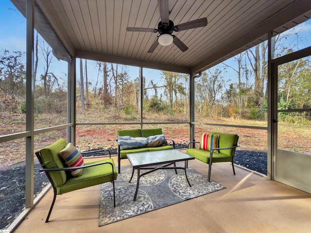 sunroom featuring ceiling fan and a wealth of natural light