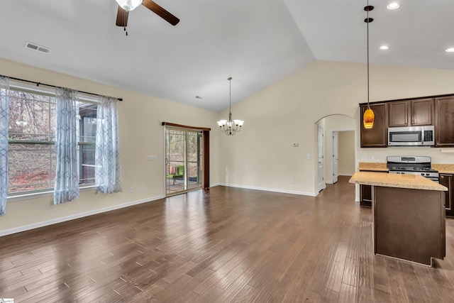 kitchen featuring decorative light fixtures, dark brown cabinetry, stainless steel appliances, and a wealth of natural light