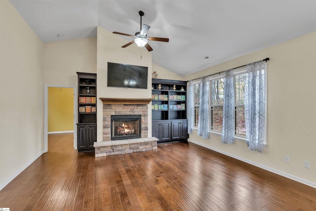 unfurnished living room with vaulted ceiling, ceiling fan, a fireplace, and dark hardwood / wood-style floors