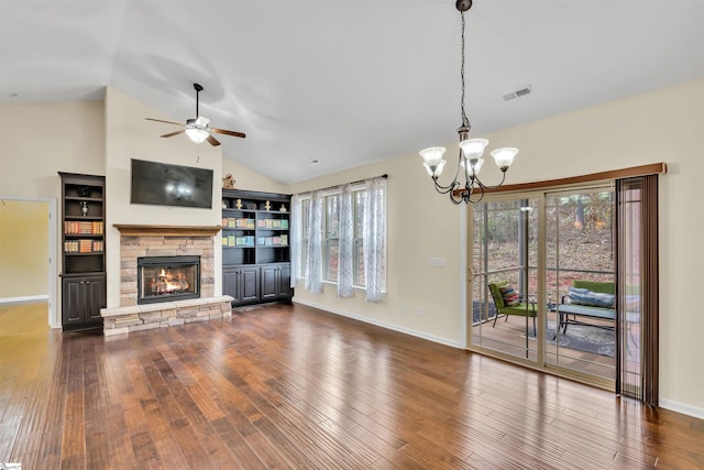 unfurnished living room featuring a fireplace, dark hardwood / wood-style flooring, vaulted ceiling, and ceiling fan with notable chandelier