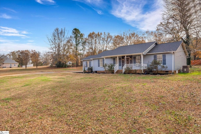 ranch-style home with covered porch, cooling unit, and a front yard