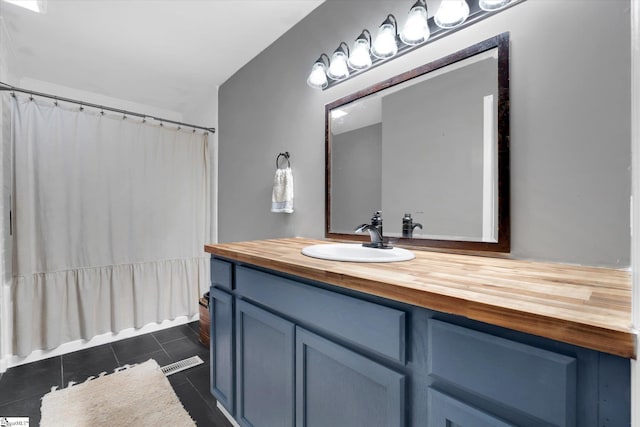 bathroom with tile patterned floors and vanity