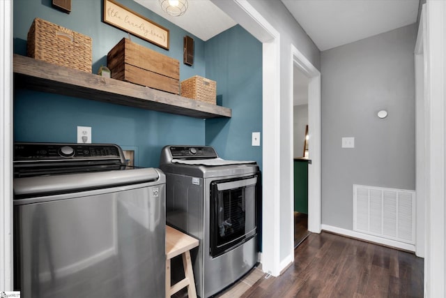 washroom with dark hardwood / wood-style flooring and washer and dryer