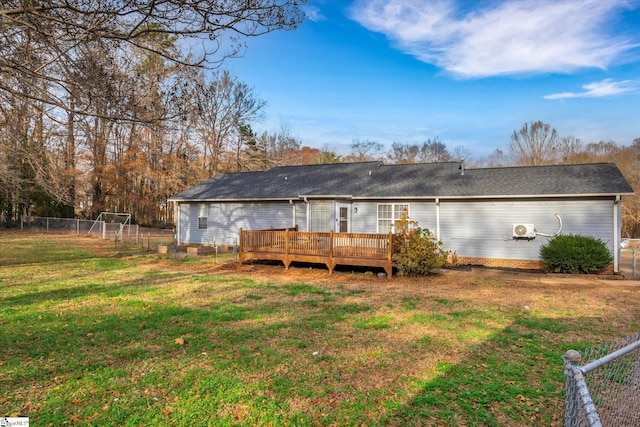 back of house with a yard and a wooden deck