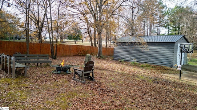 view of yard featuring a fire pit and a shed