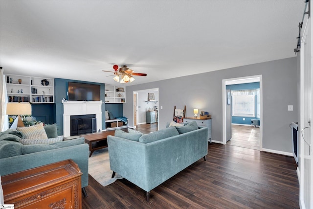 living room featuring ceiling fan, built in features, and dark hardwood / wood-style floors