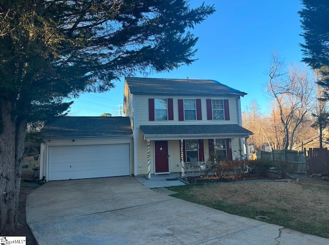 front of property featuring covered porch and a garage