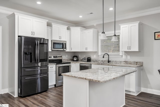 kitchen featuring appliances with stainless steel finishes, white cabinetry, hanging light fixtures, and sink