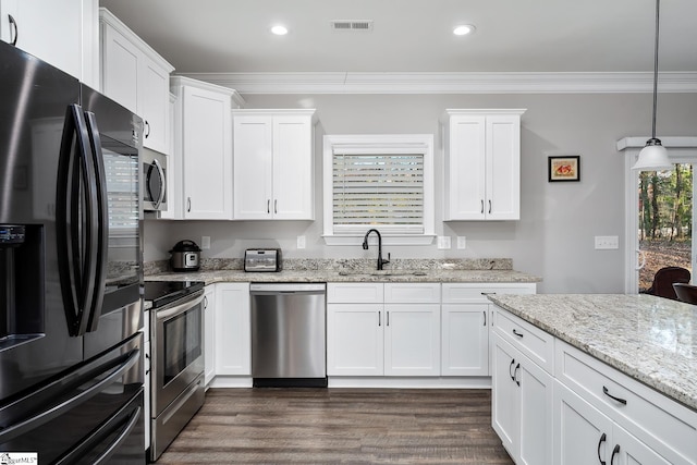 kitchen featuring light stone countertops, white cabinetry, sink, hanging light fixtures, and appliances with stainless steel finishes