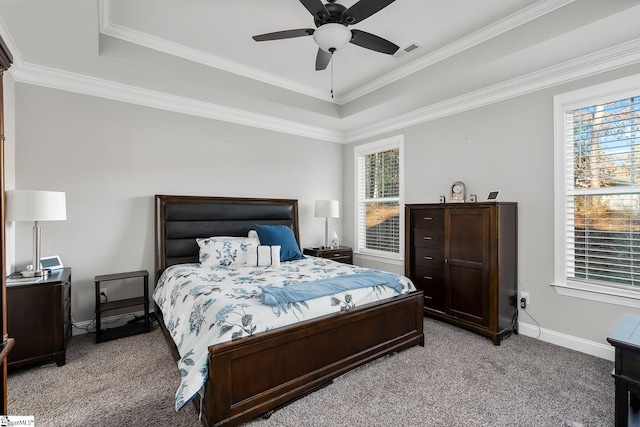 bedroom featuring light carpet, a tray ceiling, ceiling fan, and ornamental molding