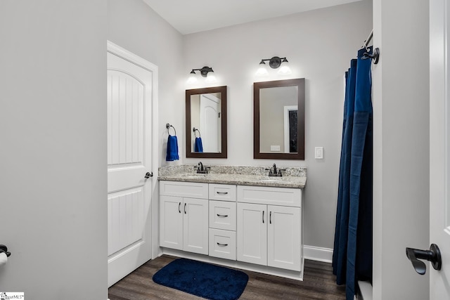 bathroom with hardwood / wood-style floors and vanity