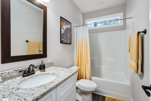 full bathroom with shower / tub combo with curtain, vanity, and toilet