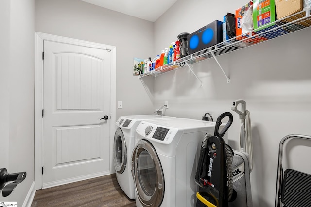 laundry area with dark hardwood / wood-style floors and washer and clothes dryer