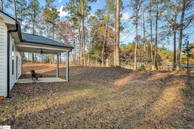 view of yard with ceiling fan and a patio area