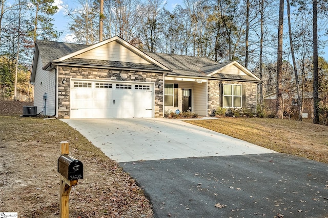 view of front facade featuring central AC and a garage