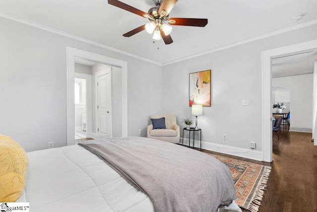 bedroom featuring connected bathroom, dark wood-type flooring, ceiling fan, and ornamental molding