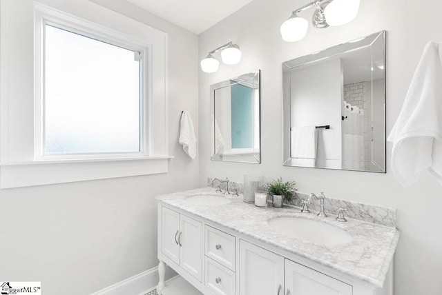 bathroom featuring vanity and curtained shower