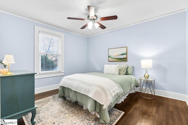 bedroom featuring ceiling fan, crown molding, and dark wood-type flooring