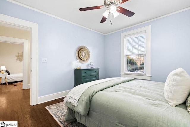 bedroom featuring dark hardwood / wood-style floors, ceiling fan, and crown molding