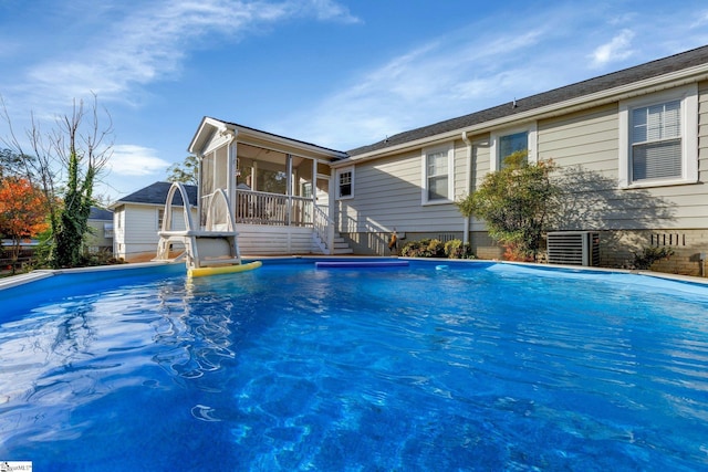 view of swimming pool featuring a sunroom