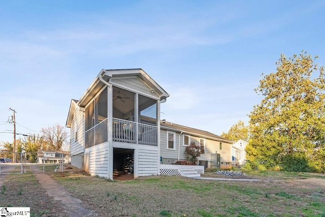 back of property with a sunroom