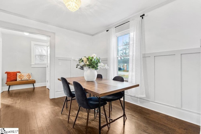 dining space featuring crown molding and dark wood-type flooring