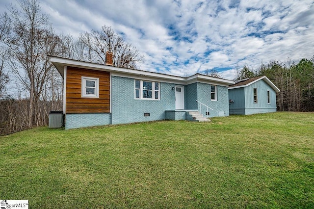 rear view of property featuring a yard