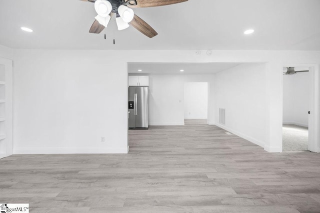 spare room with ceiling fan and light hardwood / wood-style floors