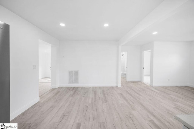 empty room with light hardwood / wood-style flooring