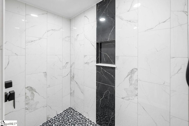 bathroom with a tile shower