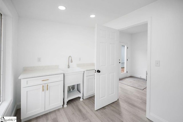 laundry area featuring light hardwood / wood-style flooring