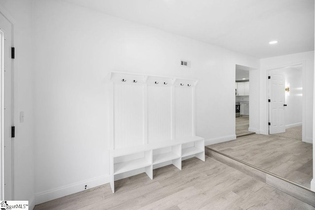 mudroom with light hardwood / wood-style flooring