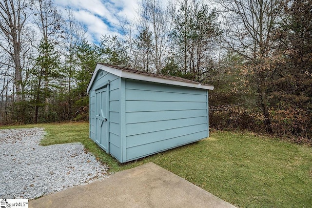 view of outbuilding with a lawn