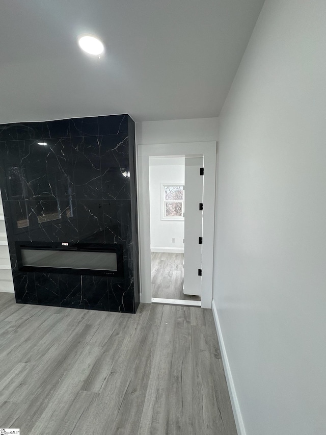 hallway with light hardwood / wood-style floors