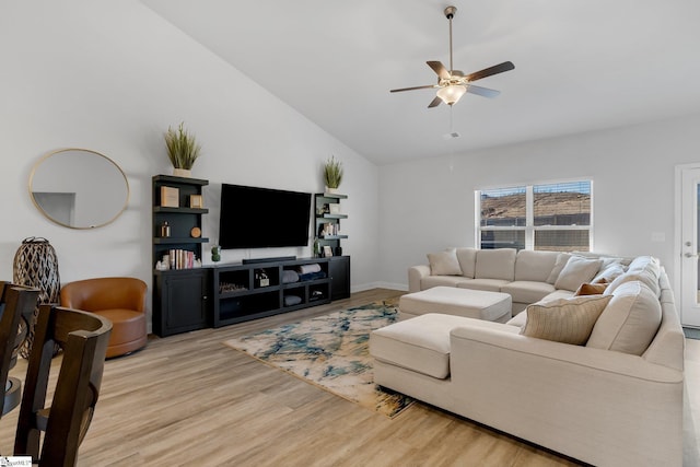 living room with ceiling fan, light wood-type flooring, and lofted ceiling