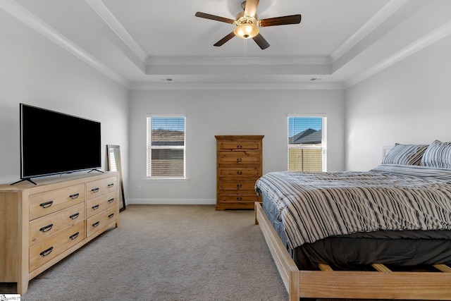 bedroom with multiple windows, a raised ceiling, and ceiling fan