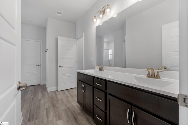 bathroom featuring vanity, wood-type flooring, and walk in shower