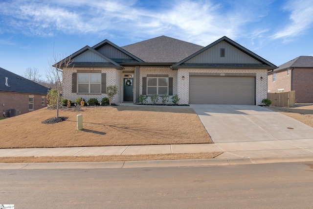 craftsman house with a garage and central air condition unit